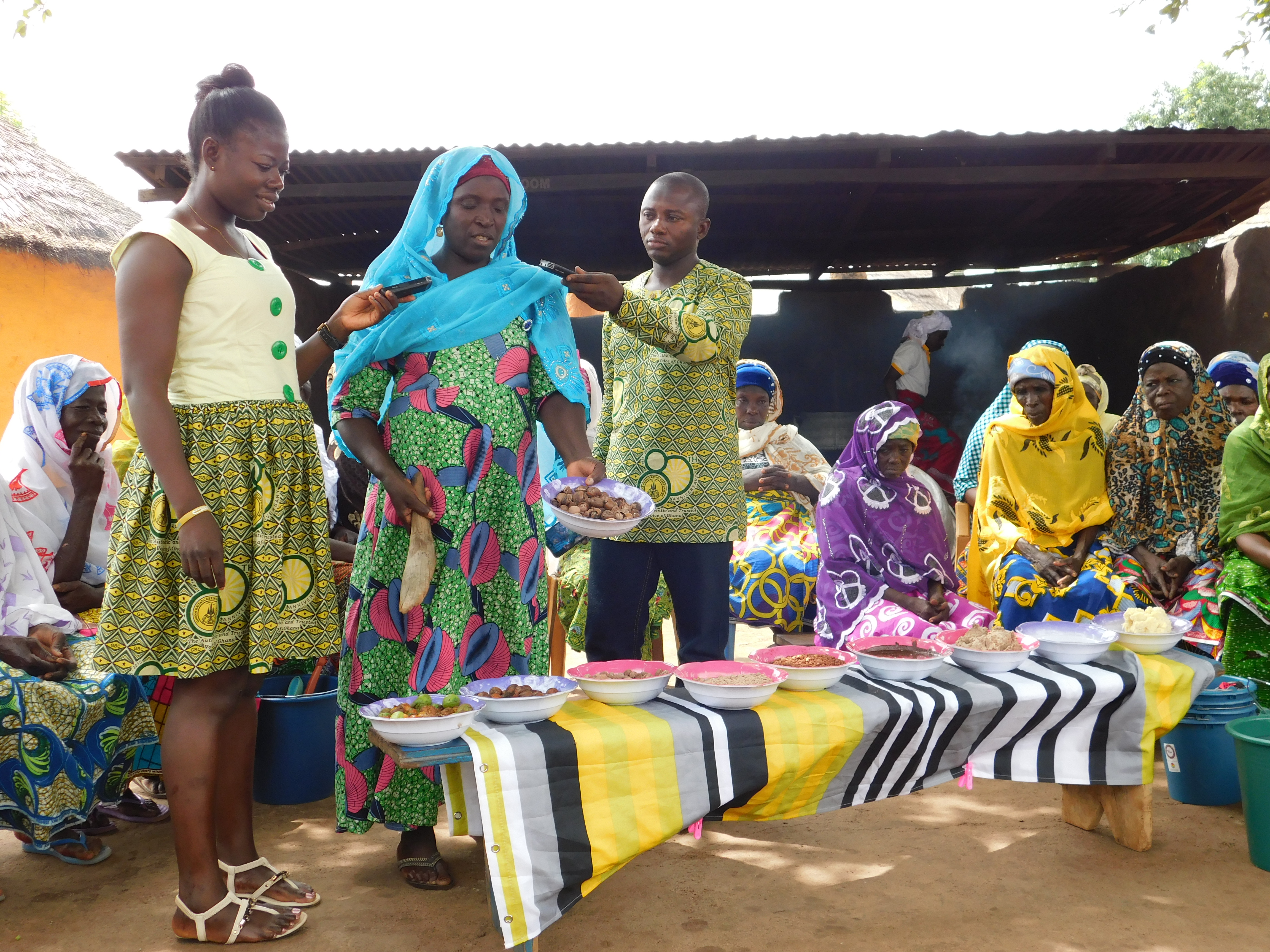 Radio presenters interview a shea butter cooperative leader.