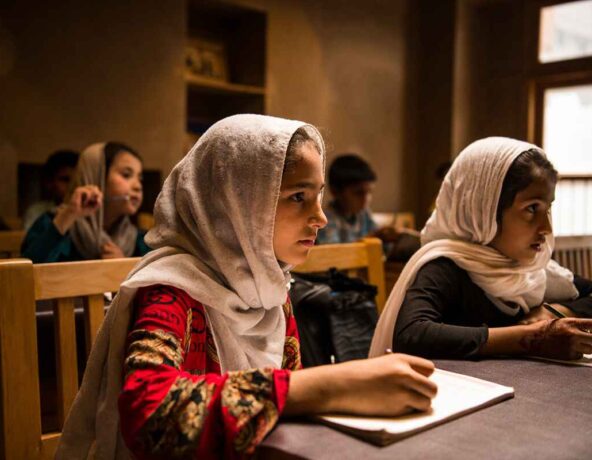 Children sitting at desks in a classroom