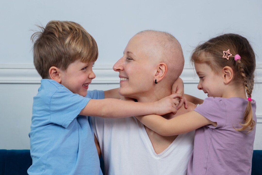 Smiling cancer patient with two children